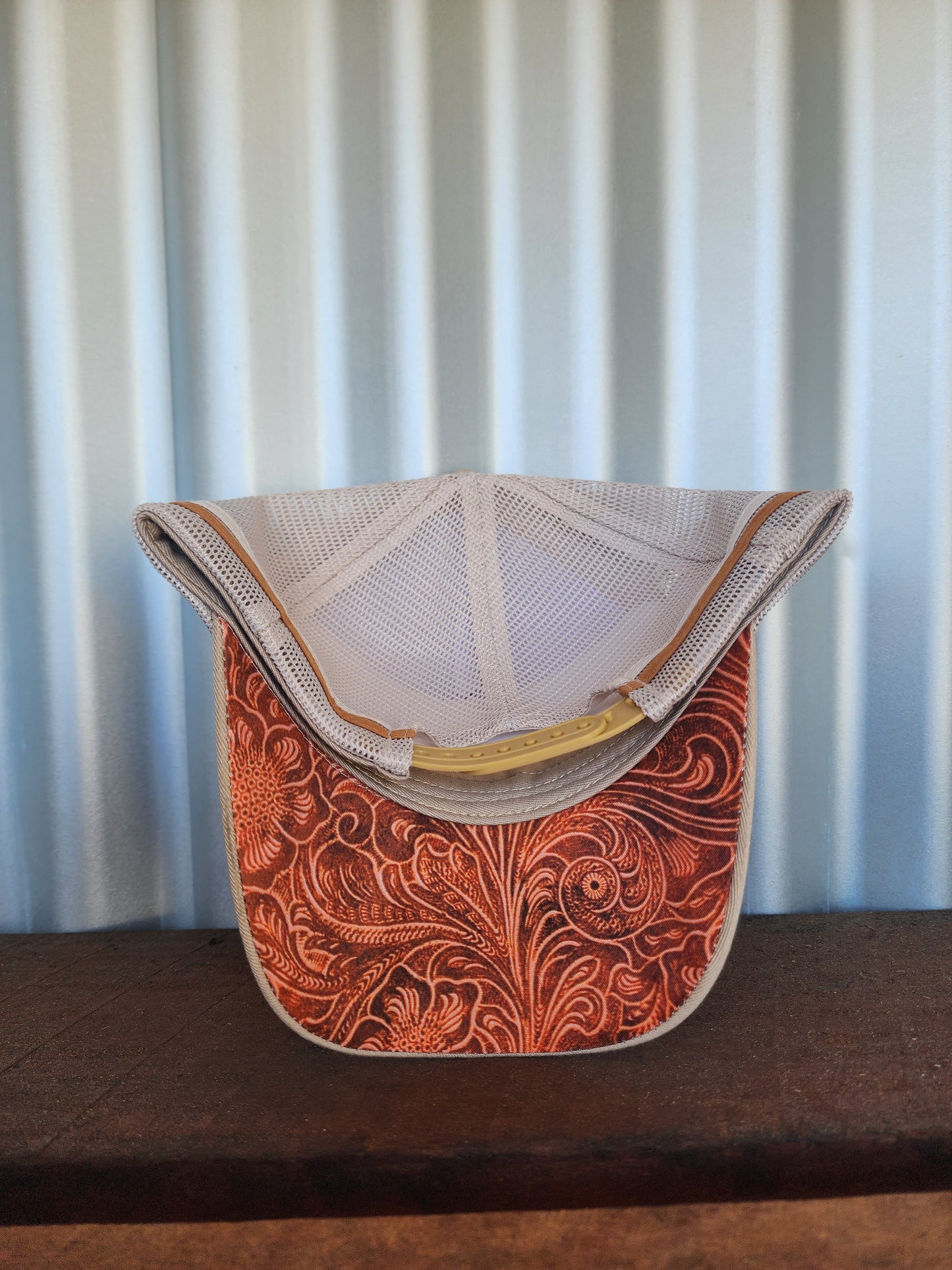 Tan with imitation embossed pattern under brim. (Patch)