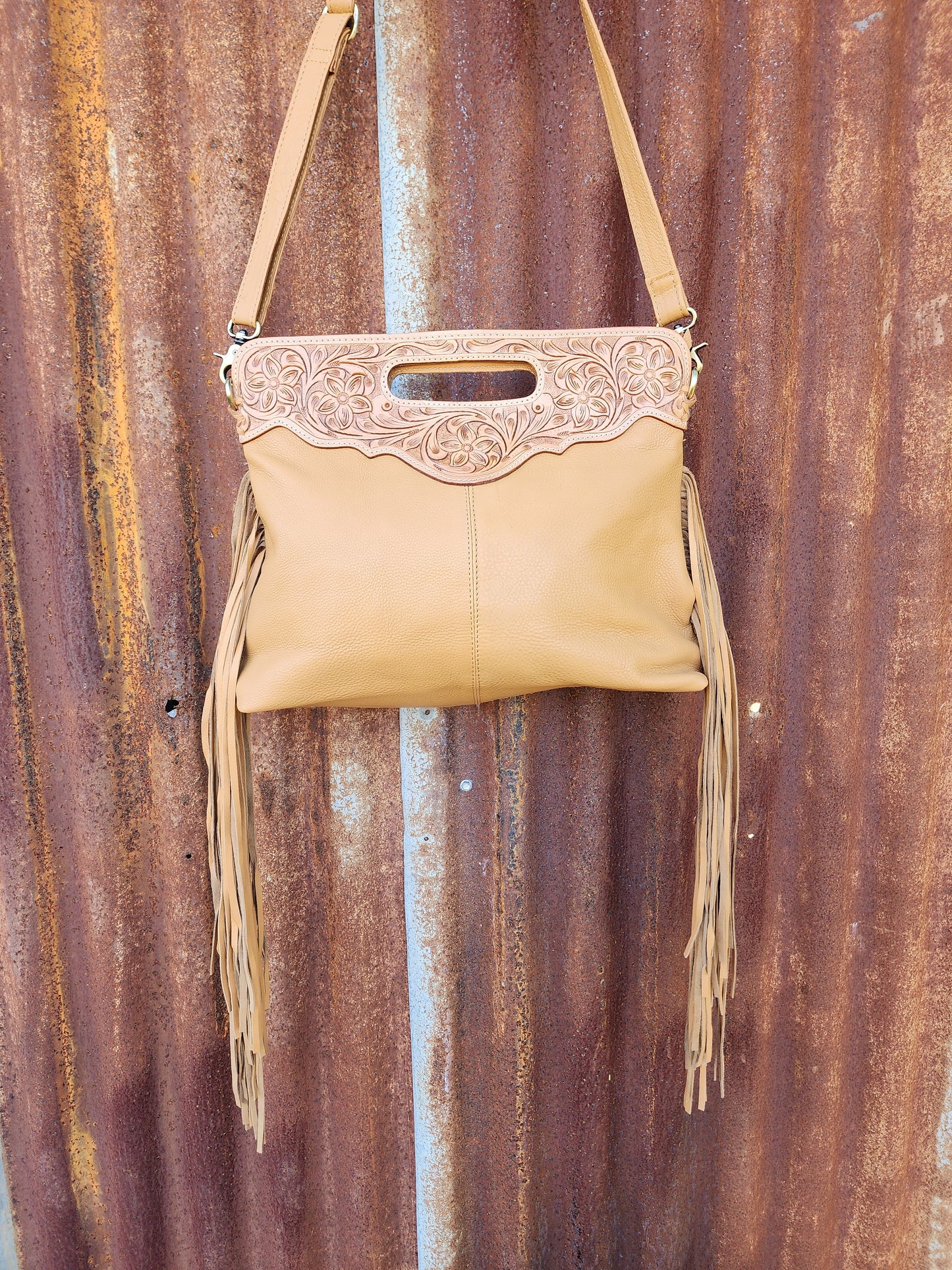 Large Tooled Tan and white tassled bag.