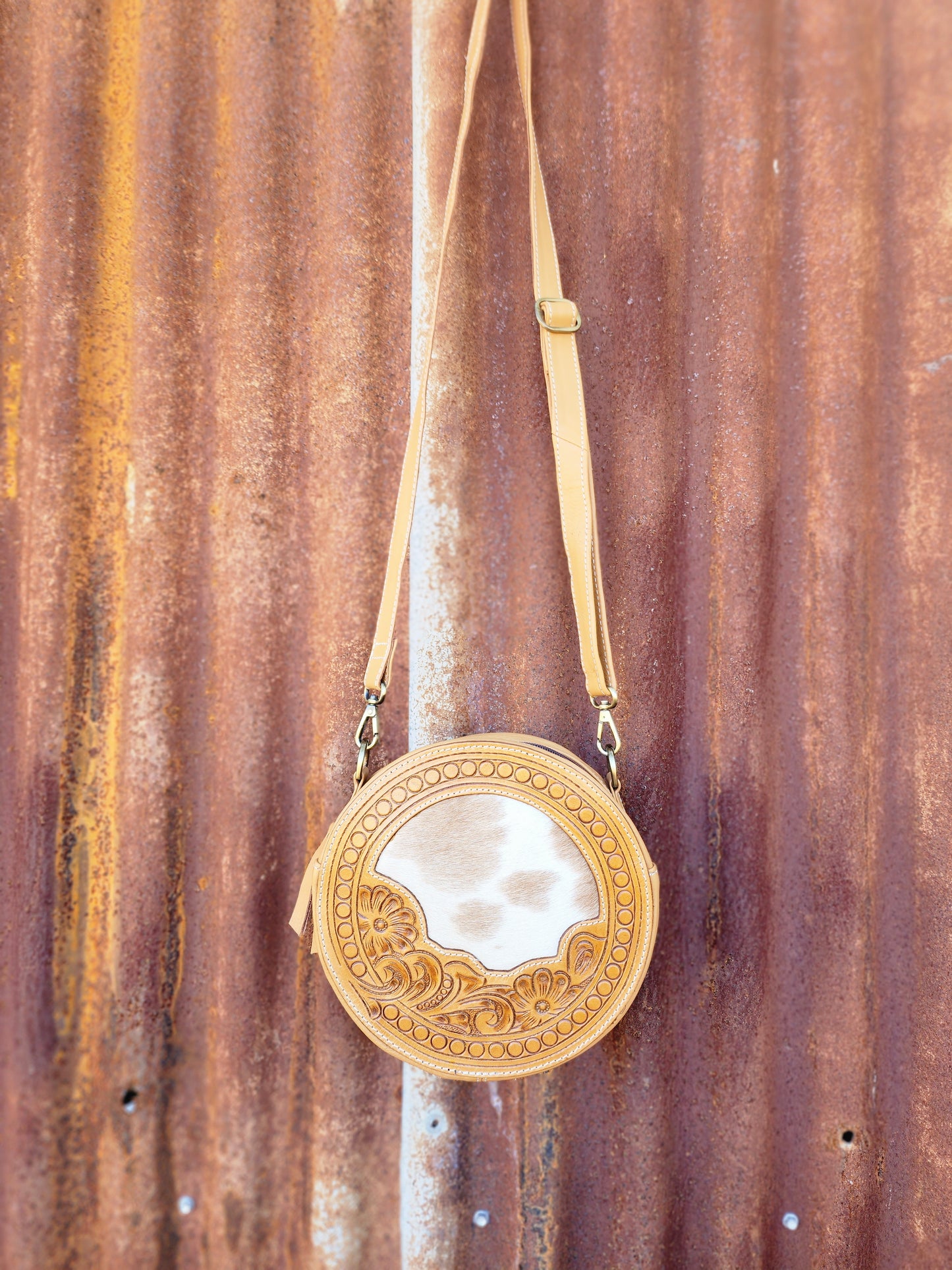 Round Tan and white tooled hand bag